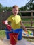 Child playing Colourful balls and buckets in childs sand pit