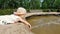 Child playing in fountain at city park on sunny summer day