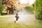 Child playing with garden sprinkler