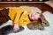 Child playing with grey rabbit. Young boy lying relaxed with his eyes shut