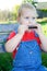 Child playing harmonica.