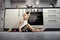 Child playing in the kitchen with a gas stove.