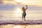 Child playing on ocean beach. Kid at sunset sea