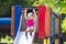 Child playing on outdoor playground in summer