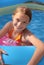 Child playing in paddling pool