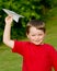 Child playing with paper airplane