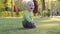 A child is playing in the park on the grass. Boy, blond, baby, first steps