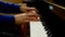 Child playing piano. Close up side view of young hands and fingers playing a song on the keys.