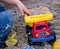 Child Playing with Plastic Truck in Sand