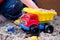 Child Playing with Plastic Truck in Sand