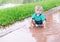 Child playing in a puddle