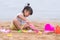 Child playing sand beach, on the beach on summer holidays. Children building a sandcastle at sea