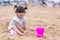 Child playing sand beach, on the beach on summer holidays. Children building a sandcastle at sea
