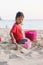 Child playing sand beach, on the beach on summer holidays. Children building a sandcastle at sea