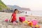 Child playing sand beach, on the beach on summer holidays. Children building a sandcastle at sea