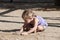 Child playing with sand on the playground