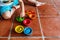 Child playing with a set of colored bowls to fill them with pieces of the right color, while learning to count by manipulating the