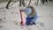 Child playing with snow shovel in the park