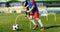 Child playing soccer ball on practice unit. School physical education class for kids