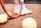 Child playing tennis on outdoor court. Cropped image of child legs on tennis court. Closeup of tennis ball, racket and shoes.