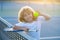 Child playing tennis on outdoor court. Tennis is my favorite play. Portrait of a pretty sporty child with a tennis