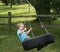 Child playing on a tire swing