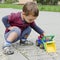 Child playing with toy car