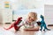 Child playing with toy dinosaurs. Kids toys