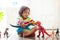Child playing with toy dinosaurs. Kids toys
