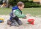 Child playing toy and stones in park