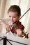 Child playing violin at home