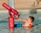 Child playing with water cannon at kiddie pool