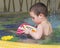 Child playing in water in children pool