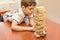 A child playing wood blocks stack game