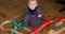 Child playing with wooden train