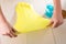 Child playing with yellow and blue slime on wooden table