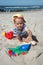 Child playint with toys on the beach