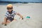 Child playint with toys on the beach