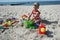 Child playint with toys on the beach