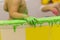 The child plays in the bathroom, draws with finger paints, the bathroom in the paint, green paint flows down the wall.baby hands