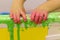 The child plays in the bathroom, draws with finger paints, the bathroom in the paint, green paint flows down the wall.baby hands