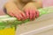 The child plays in the bathroom, draws with finger paints, the bathroom in the paint, green paint flows down the wall.baby hands