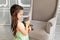 A child plays with a cat at home, a little girl holds a cat in her arms, the concept of a child`s friendship with animals