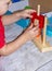 A child plays with educational wooden toys with colored details.