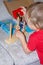 Child plays educational wooden toys with colored details