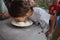 Child plays fetch a prize in a bowl of flour