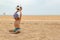 The child plays football on the beach.