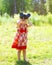 Child plays looks in binoculars outdoors in summer