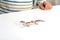 Child plays with pet lizard or Eublepharis on white table at home