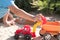 A child plays in the sand with big toy cars, an excavator, a truck